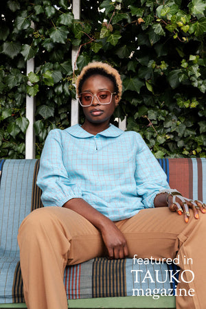Helmi woven blouse with peter pan collar in blue plaid linen, front view, seated